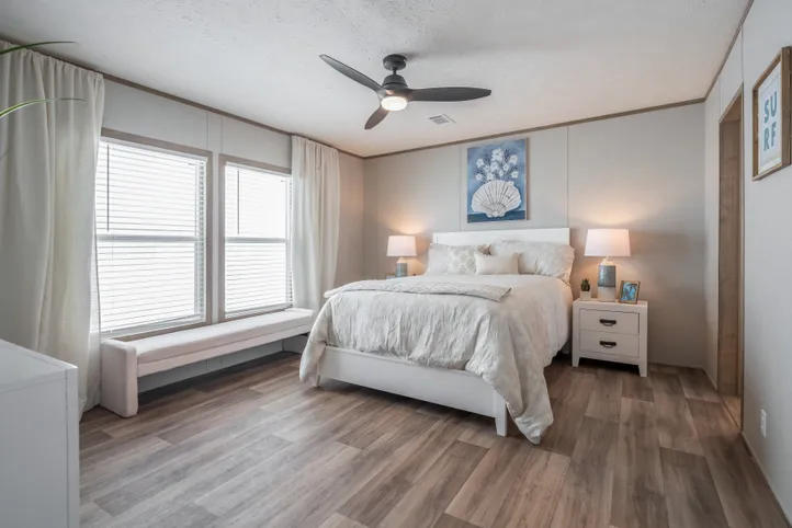 The EL SUENO BREEZE Primary Bedroom. This Manufactured Mobile Home features 4 bedrooms and 2 baths.