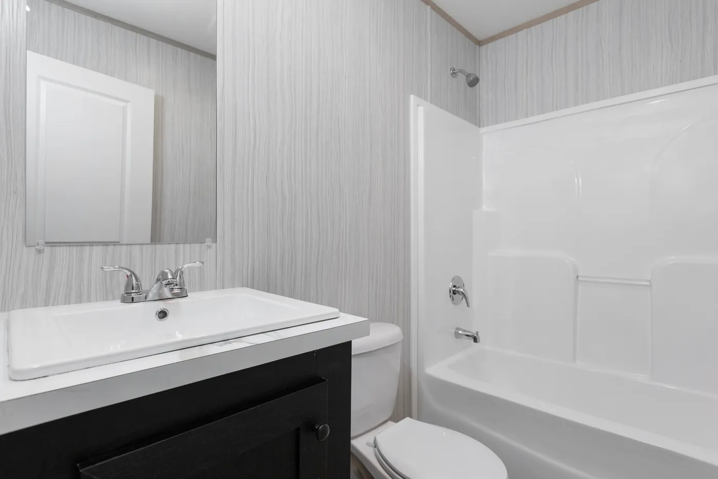 The THE THUNDERHEAD Guest Bathroom. This Manufactured Mobile Home features 3 bedrooms and 2 baths.