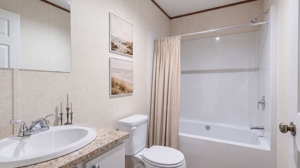 The REDWOOD Guest Bathroom. This Manufactured Mobile Home features 5 bedrooms and 3 baths.