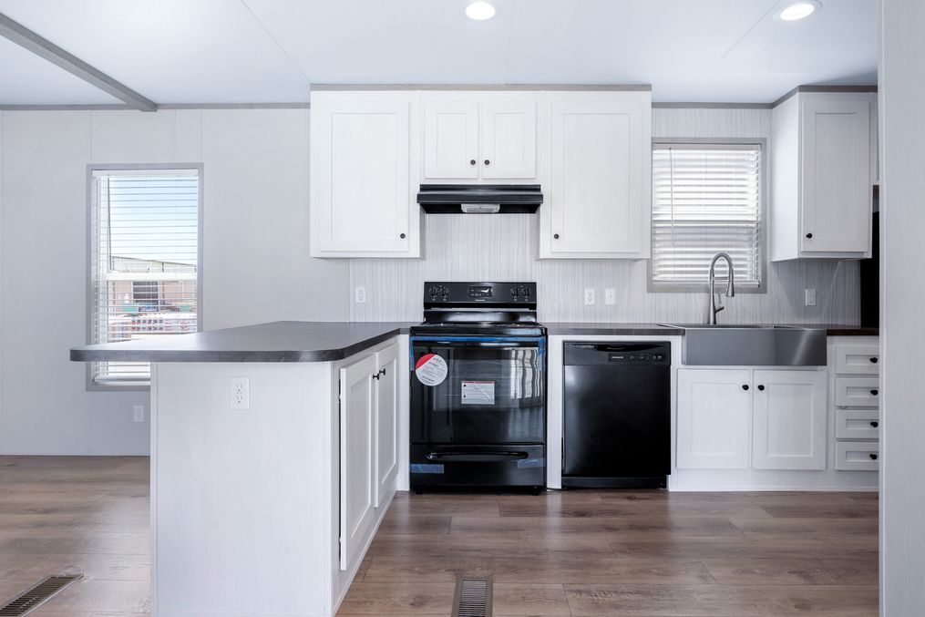 The ANNIVERSARY 16602A Kitchen. This Manufactured Mobile Home features 2 bedrooms and 2 baths.