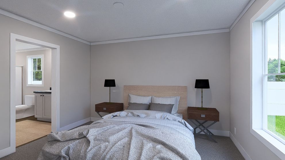 The UNDER PRESSURE Primary Bedroom. This Manufactured Mobile Home features 3 bedrooms and 2 baths.