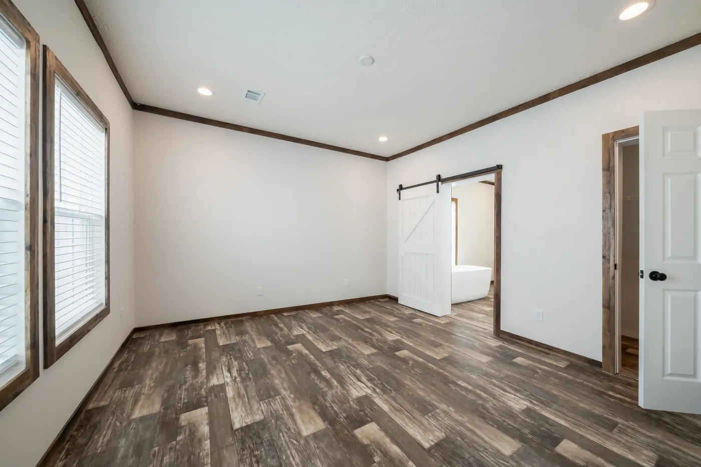 The 3237 THE TYBEE HUD Primary Bedroom. This Manufactured Mobile Home features 4 bedrooms and 3 baths.