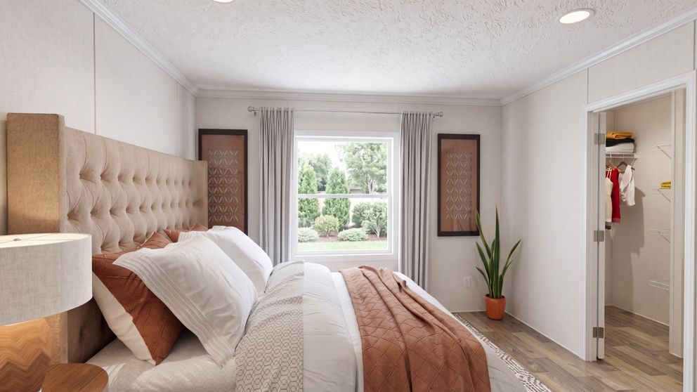 The HICKORY Primary Bedroom. This Manufactured Mobile Home features 3 bedrooms and 2 baths.