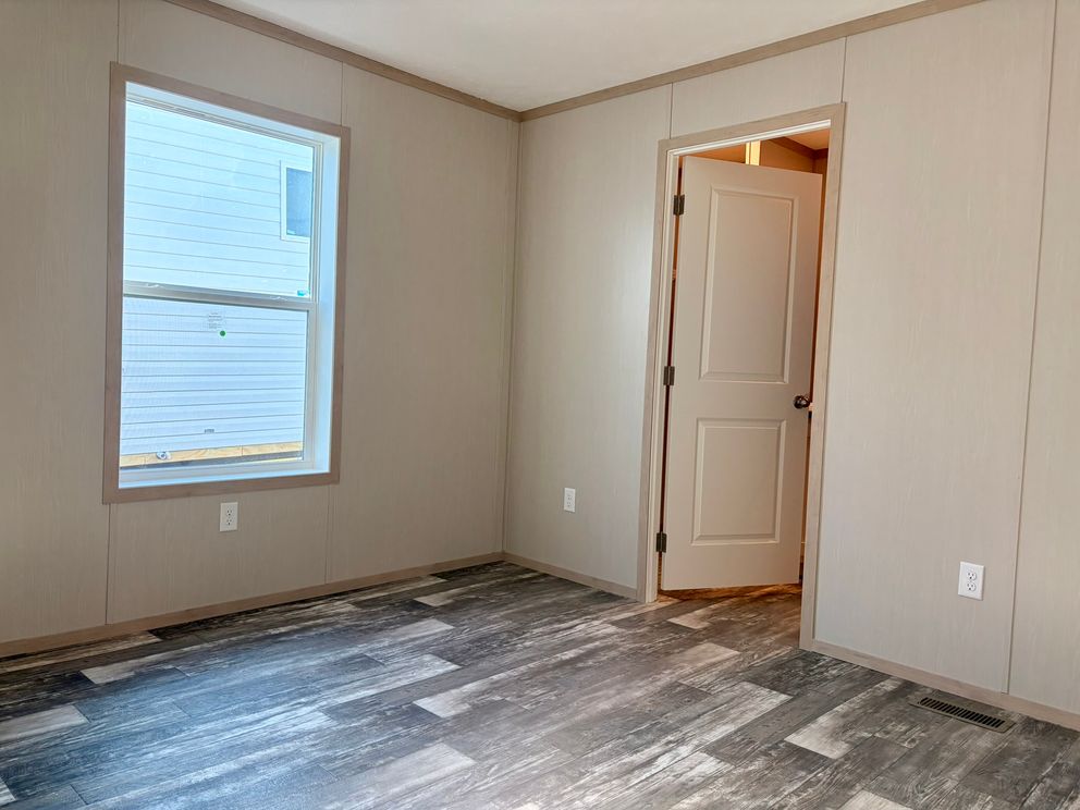 The JEFFERSON Primary Bedroom. This Manufactured Mobile Home features 3 bedrooms and 2 baths.