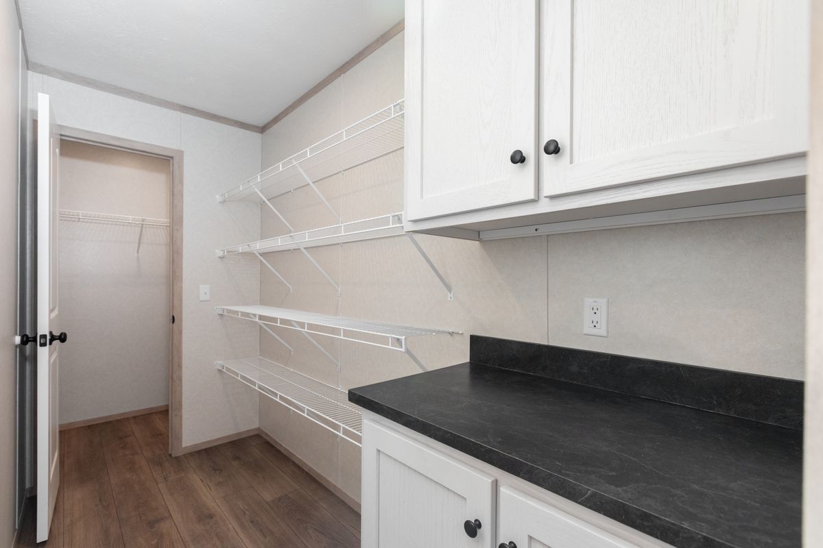 The 6032-5700 THE PULSE Storage. This Manufactured Mobile Home features 3 bedrooms and 2 baths.