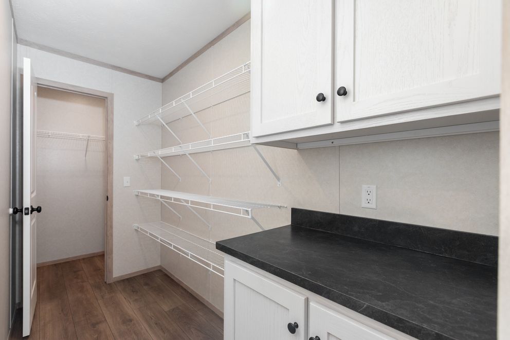 The 6032-5700 THE PULSE Storage. This Manufactured Mobile Home features 3 bedrooms and 2 baths.