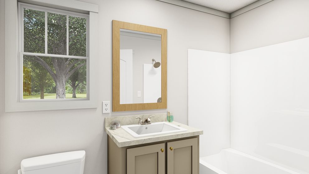 The SATISFACTION Primary Bathroom. This Manufactured Mobile Home features 2 bedrooms and 1 bath.
