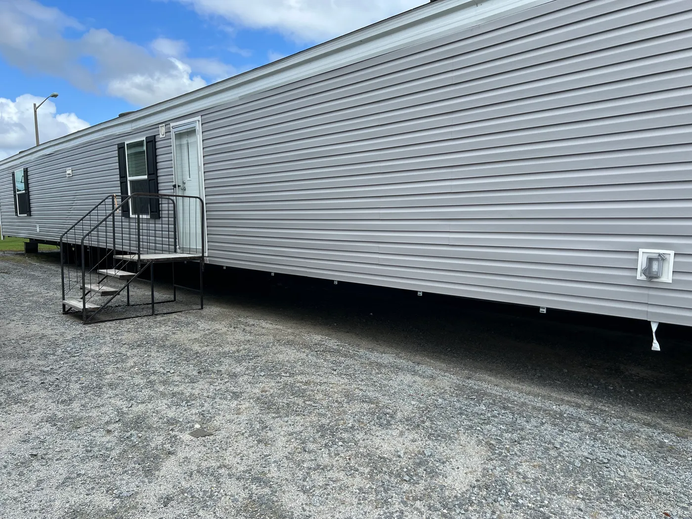 Flint siding with black shutters