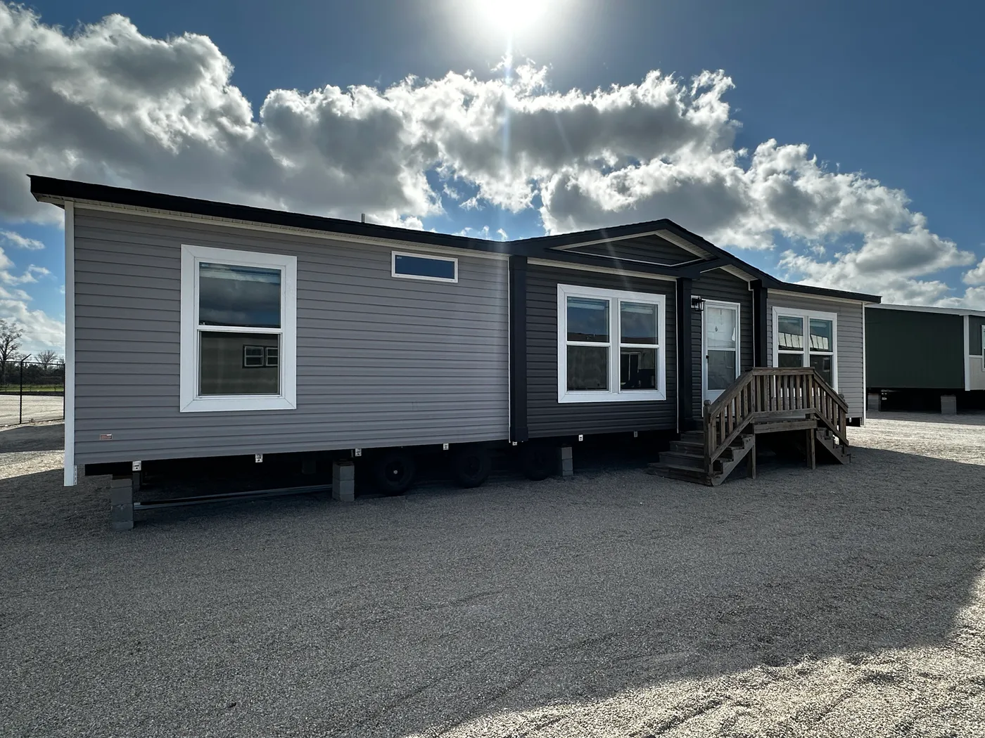 Modern luxury meets affordability in this 3 bedroom, 2 bathroom double wide manufactured home designed for comfort and style. The open-concept layout features a spacious living area with a gorgeous built-in entertainment center and plenty of natural light. The designer kitchen includes stainless steel appliances, a large kitchen island, and ample cabinet space, perfect for cooking and entertaining. Enjoy enhanced comfort with energy-efficient upflow ceiling vents for improved airflow throughout 