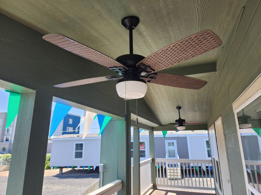 Large 27' wide covered front porch with two ceiling fans.
