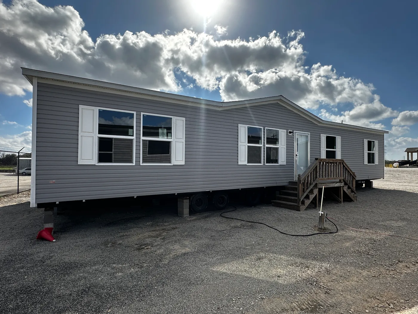 Discover the most affordable and spacious 4 bedroom, 2 bath doublewide manufactured home on the market! This budget-friendly mobile home features elevated ceilings, an open-concept layout, and plenty of room to grow with both a living room and separate den—perfect for entertaining, relaxing, or family space. The modern kitchen includes a large center island with ample storage and workspace. The private primary suite offers a walk-in closet, plus a luxury separate soaking tub and walk-in shower f