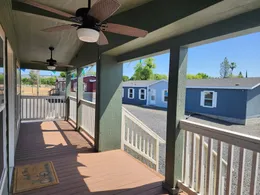 Large 27' wide covered front porch with two ceiling fans.