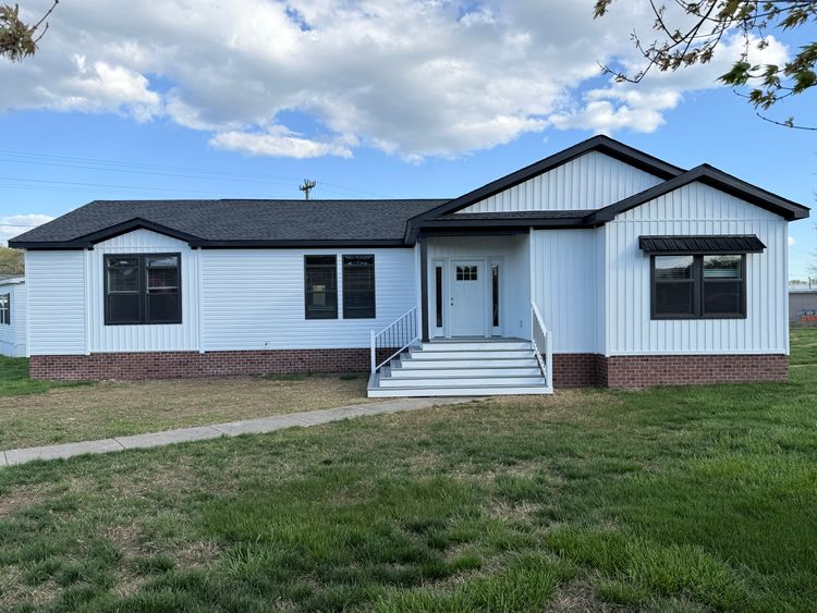 Farm House style exterior siding, black facia boards, soffits, windows, and awnings. Front covered entryway 