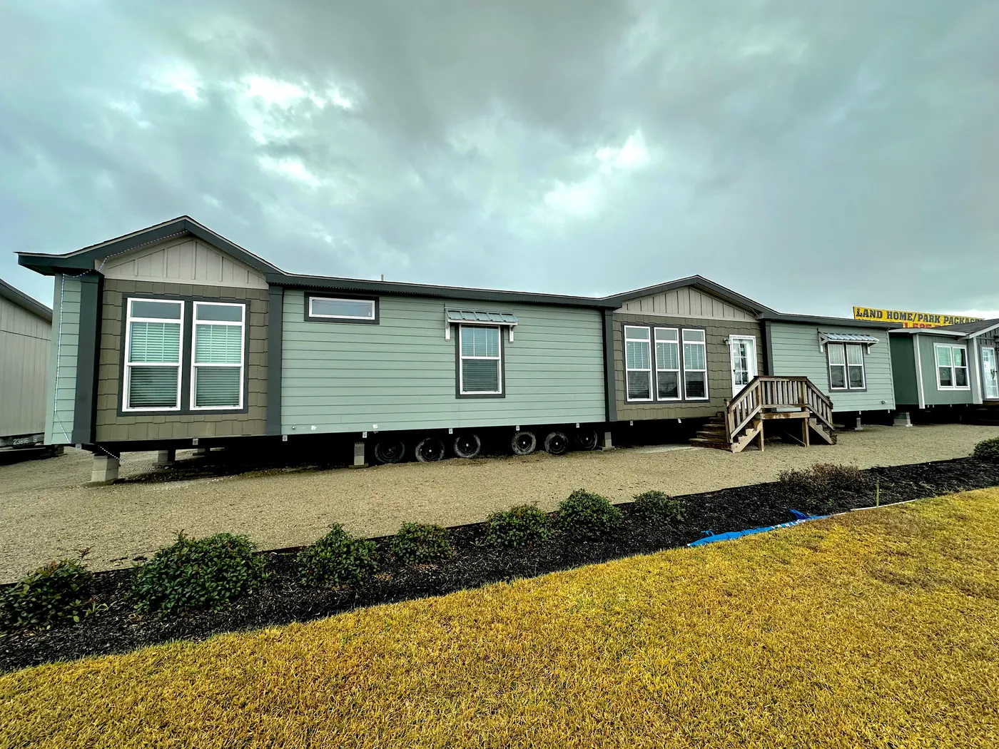 Discover this spacious 4 bedroom, 3 bathroom doublewide mobile home offering 2,304 sq ft of modern, open-concept living. This luxury manufactured home features granite countertops, stainless steel appliances, a walk-in pantry, and stylish barn doors. The primary suite includes two walk-in closets, a huge tiled walk-in shower with shower tower, and a deep soaking tub. Additional highlights include vaulted ceilings with crown molding, tape and textured walls, and a convenient Jack and Jill bathroo