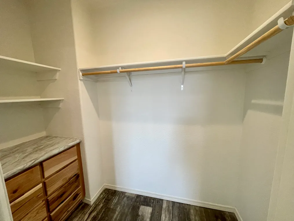 Built-in storage in a huge walk in main closet attached to the primary bathroom.