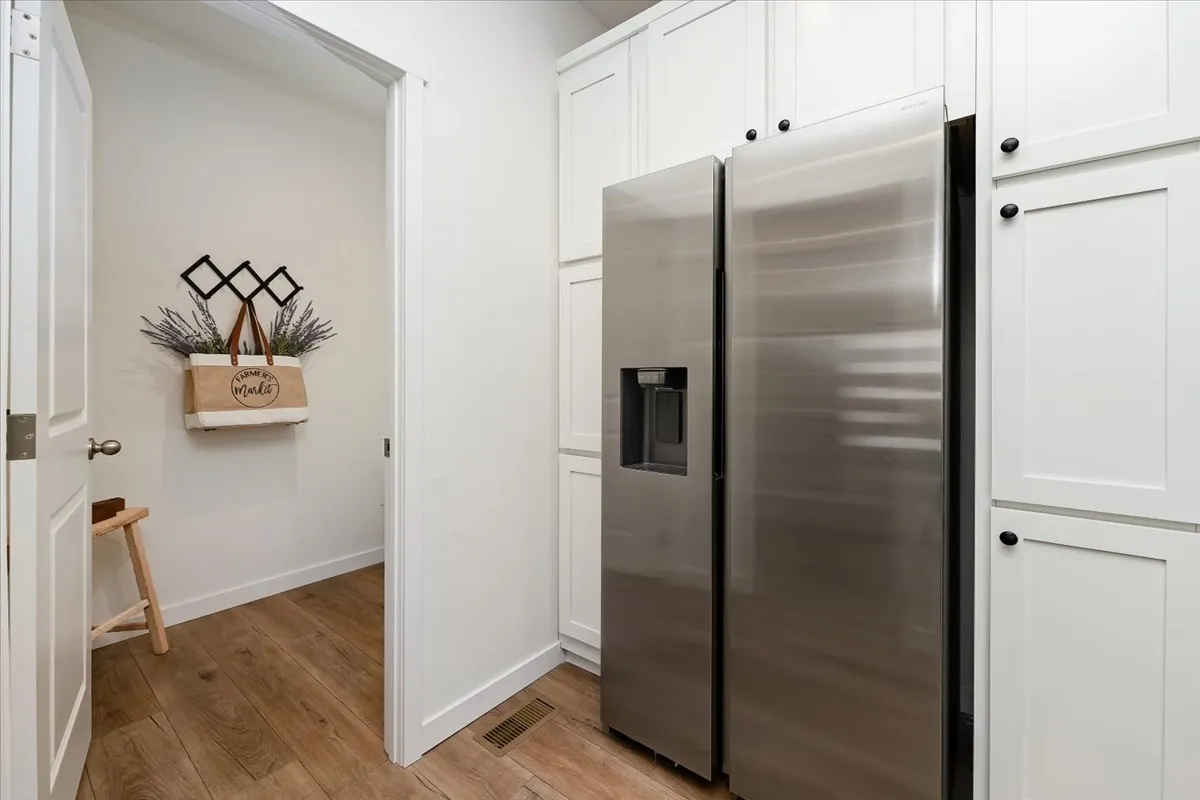 Side by side Fridge wrapped with Pantry Cabinets