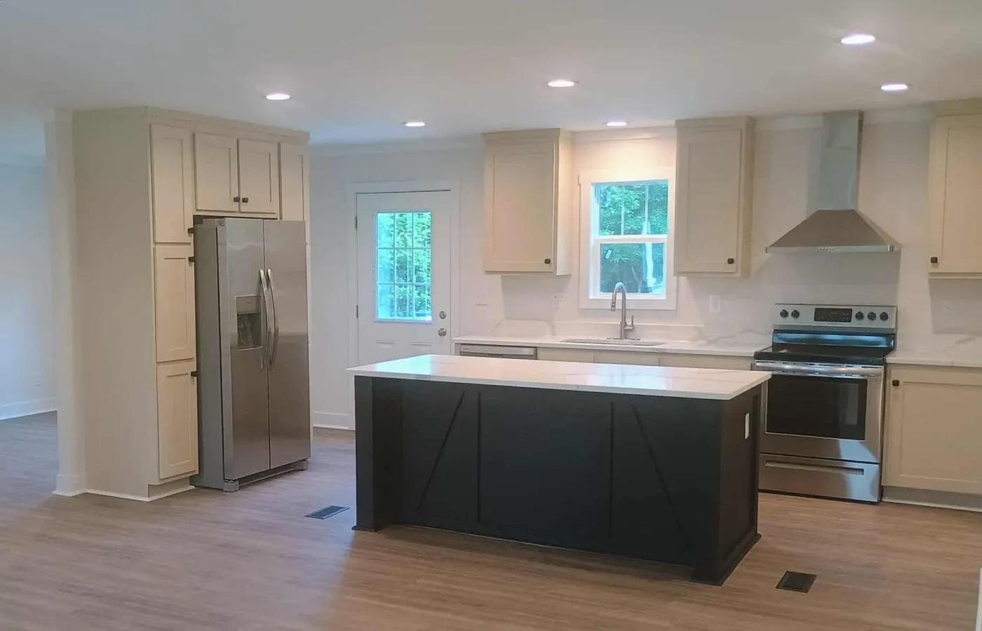 All kitchen appliances with quartz countertops and LVP flooring throughout