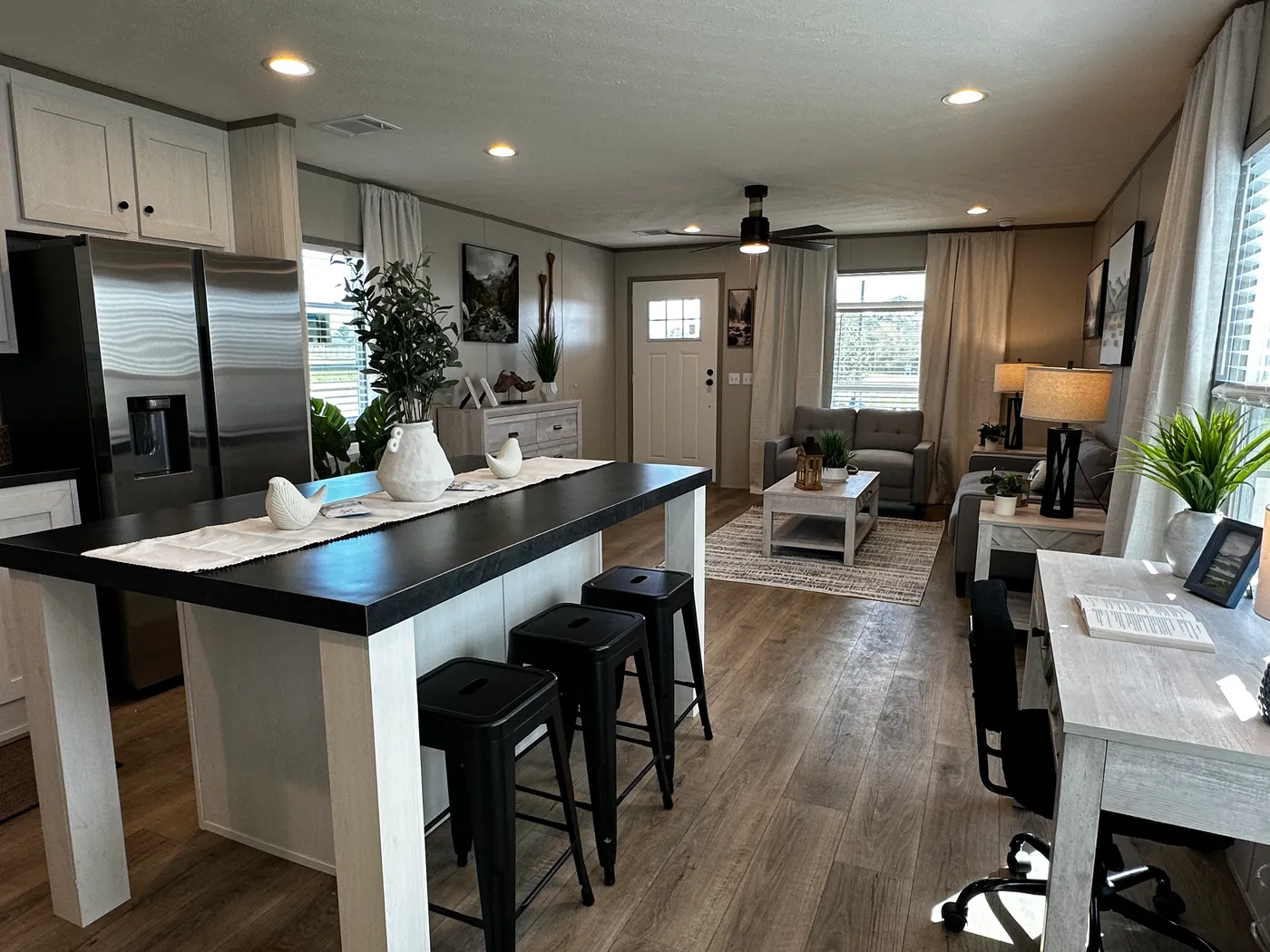 Discover this luxury porch model manufactured home featuring 2 bedrooms, 2 bathrooms, and high-end finishes designed for comfort and style. This modern manufactured home offers an open floor plan, stainless steel appliances, and a huge kitchen island perfect for entertaining. The spacious suite includes a walk-in closet and a large tiled low-profile walk-in shower for a spa-like feel. Built for durability and long-term value, this home features SmartPanel siding with a 50-year warranty, a 25-yea