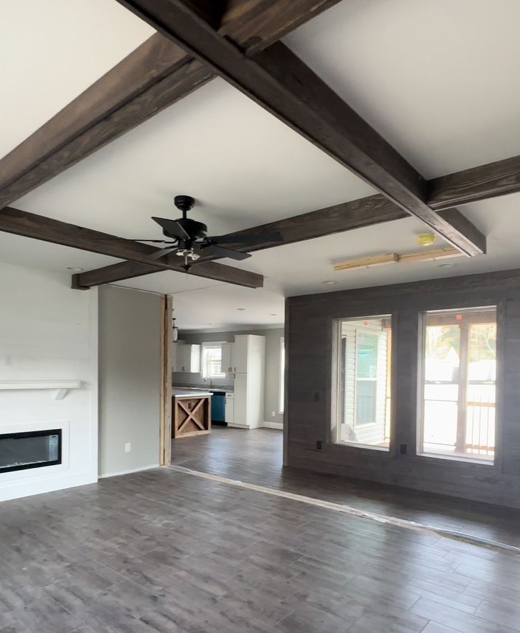 Electric Fireplace, wood ceiling beams, and Real wood shiplap are just a few options that give this home a rustic feel. 