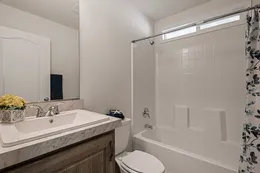 Guest bath with one-piece soaking tub/shower combo