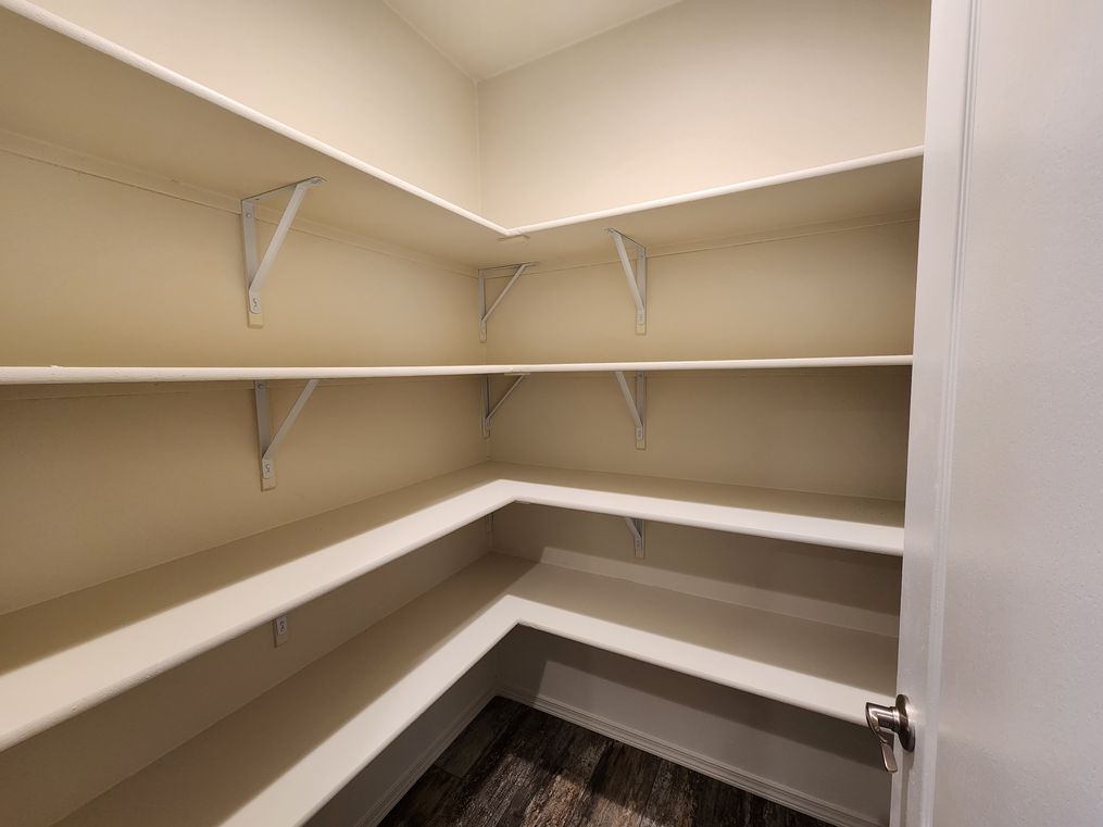 Large walk in pantry with multiple shelves
