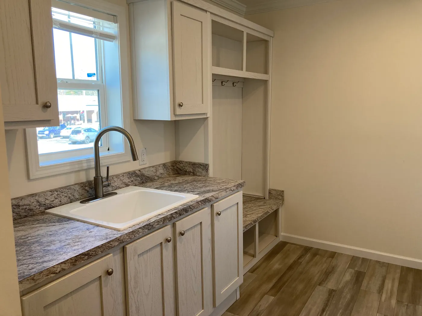 built in cabinets, coat rack and sink