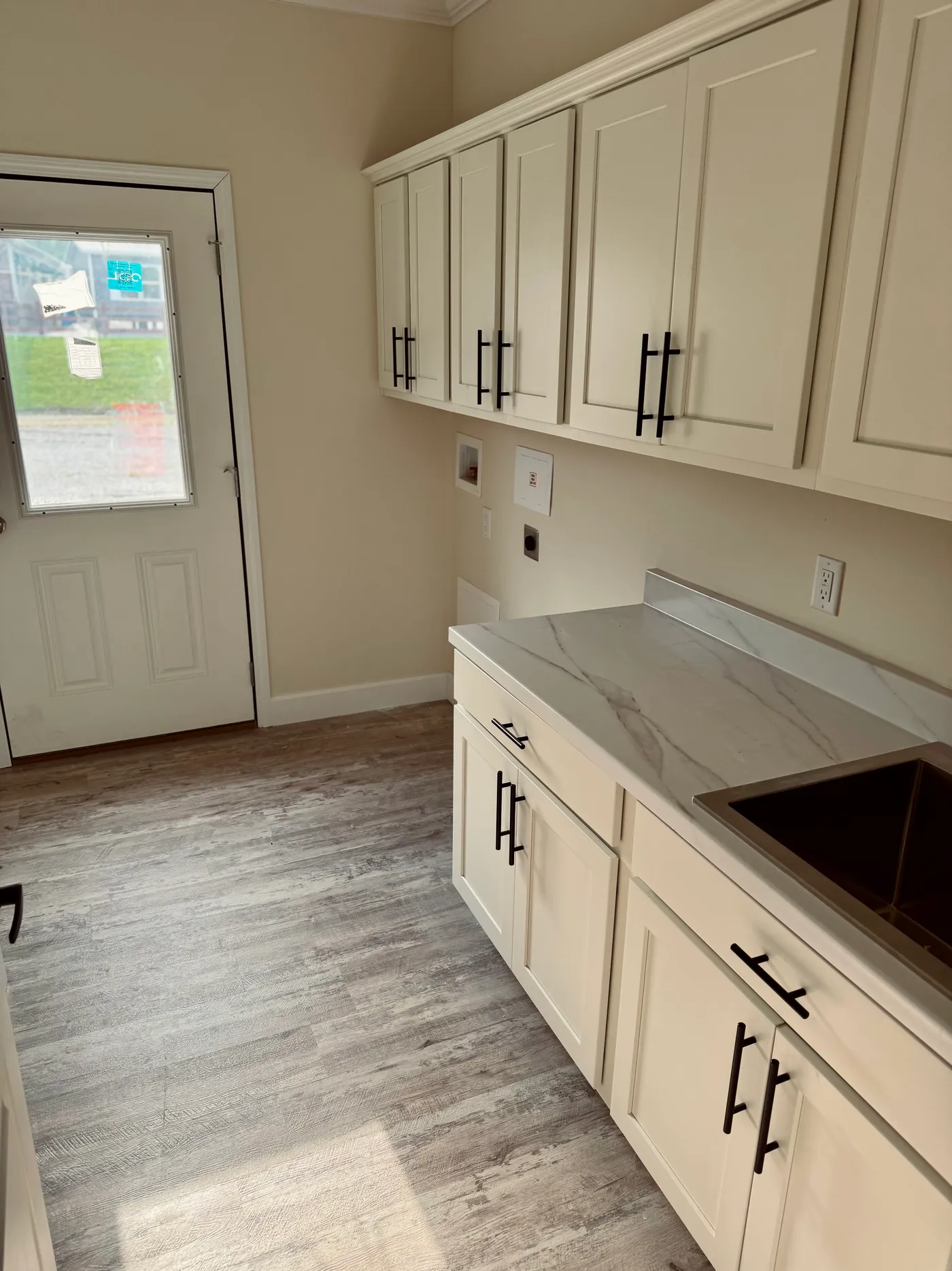 Rear exit and spacious. Perfect for a mudroom or additional pantry space.