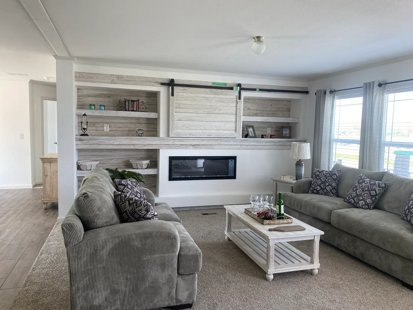 Amazing built shelves, electric fire place, and sliding barn door to cover the tv.  