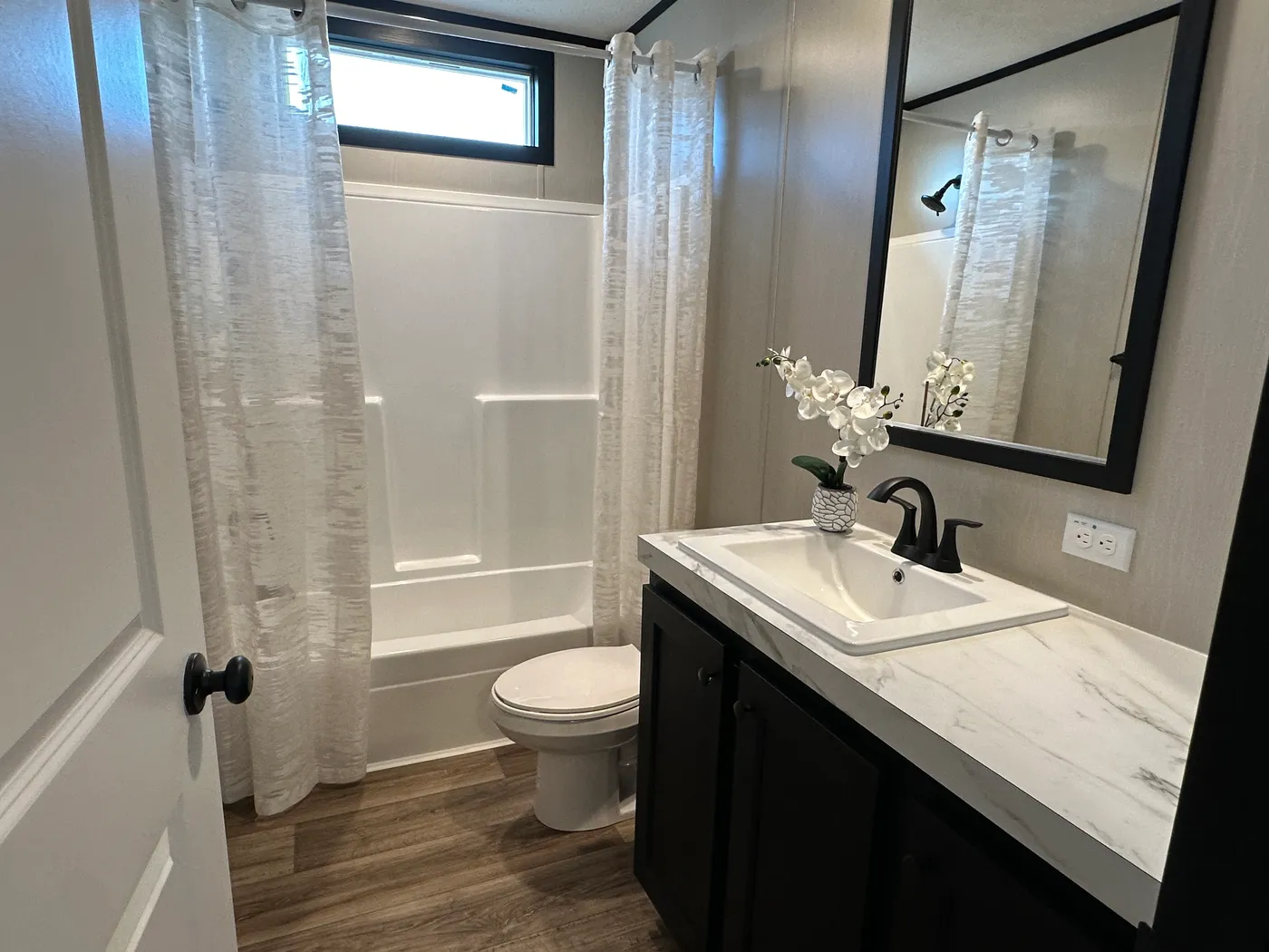 Discover The Heritage, a beautiful 3-bedroom, 2-bath manufactured home offering 1,568 square feet of spacious, functional living at Clayton Homes of Alvin, Texas! This stunning home features a spacious open-concept living room, a modern kitchen with an oversized multifunctional island, and a beautiful built-in fireplace. Enjoy a thoughtfully designed private split-bedroom floor plan, offering comfort and separation for the entire family. The oversized utility and laundry room features a convenie