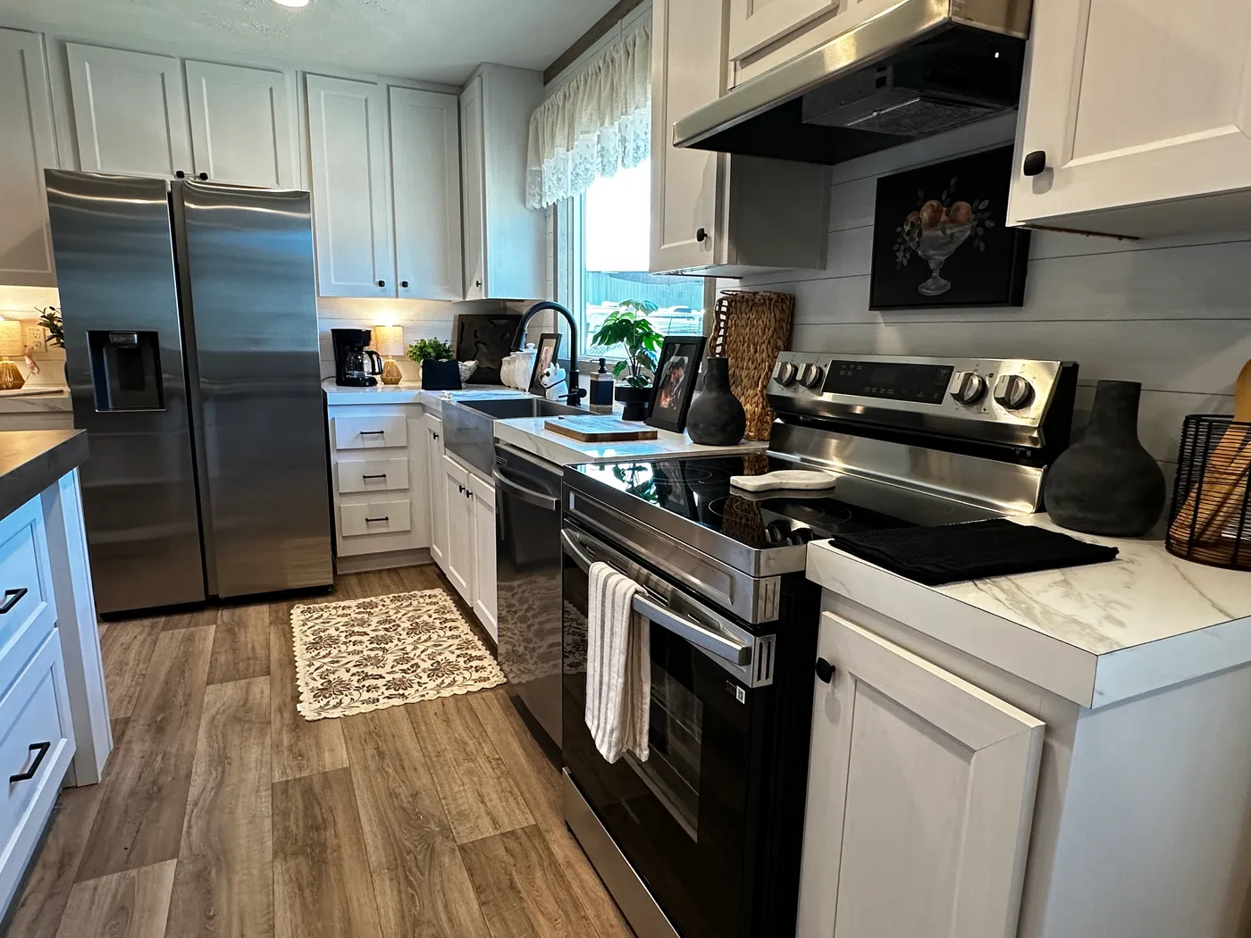 Modern luxury meets affordability in this 3 bedroom, 2 bathroom double wide manufactured home designed for comfort and style. The open-concept layout features a spacious living area with a gorgeous built-in entertainment center and plenty of natural light. The designer kitchen includes stainless steel appliances, a large kitchen island, and ample cabinet space, perfect for cooking and entertaining. Enjoy enhanced comfort with energy-efficient upflow ceiling vents for improved airflow throughout 