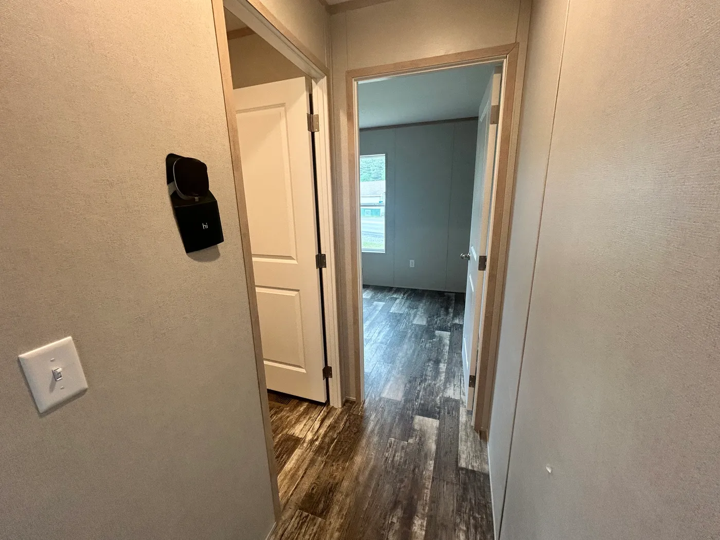 Looking down the hallway into the guest bedroom, featuring our Ecobee thermostat. 