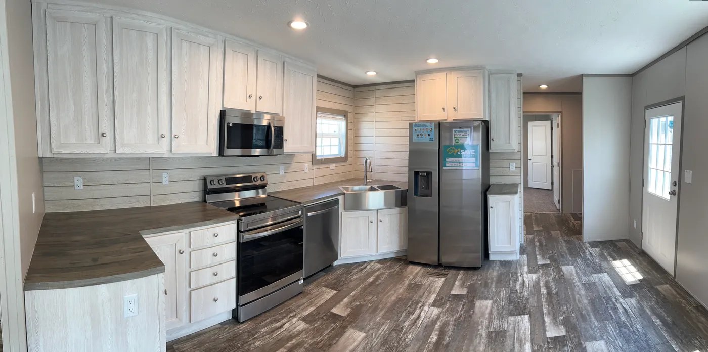 Stainless steel  appliance package with plenty of room for a table and chairs.