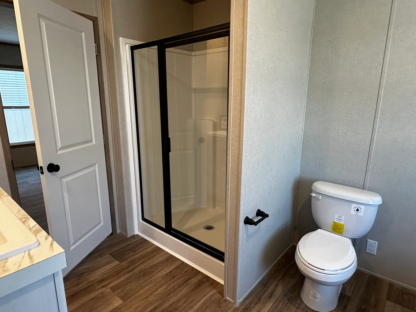 Modern luxury meets affordability in this 3 bedroom, 2 bathroom double wide manufactured home designed for comfort and style. The open-concept layout features a spacious living area with a gorgeous built-in entertainment center and plenty of natural light. The designer kitchen includes stainless steel appliances, a large kitchen island, and ample cabinet space, perfect for cooking and entertaining. Enjoy enhanced comfort with energy-efficient upflow ceiling vents for improved airflow throughout 