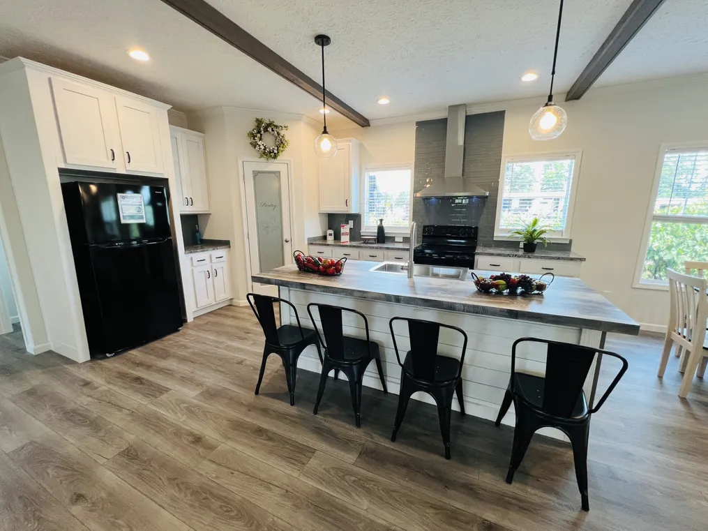 Kitchen Ceiling Beams,Tile Backsplash, Stainless Range Hood, and pendant island lights! 