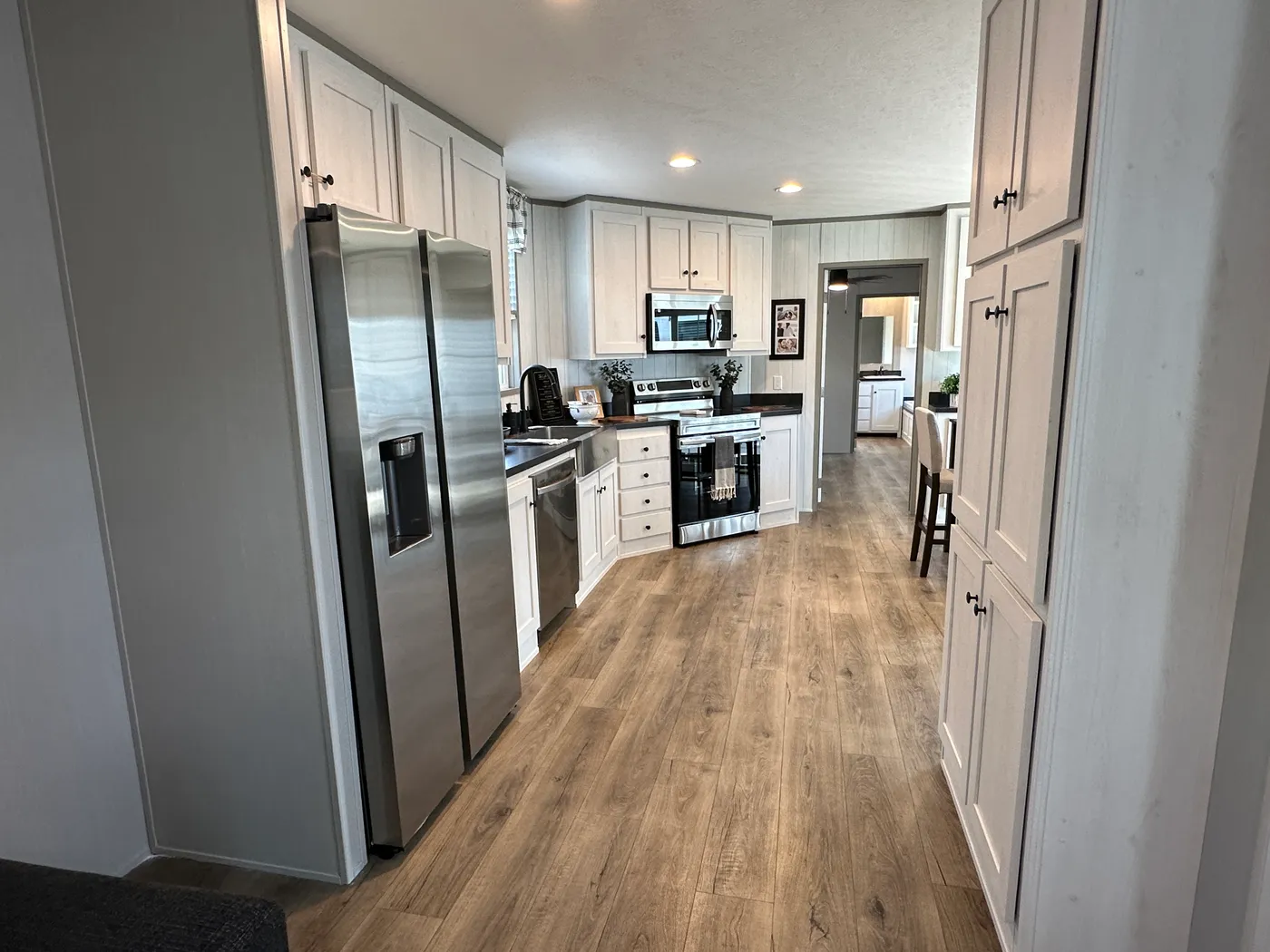 Introducing The Harvest, a beautiful 3 bedroom, 2 bathroom manufactured home with 1,216 sq. ft. of comfortable living space. This home is packed with popular upgrades, including a stainless steel farmhouse sink, a spacious kitchen design, built-in entertainment system, and upflow vents for added comfort and better furniture placement.

The private primary suite features a large garden soaking tub and separate walk-in shower, giving you the perfect place to relax after a long day. On the outsid
