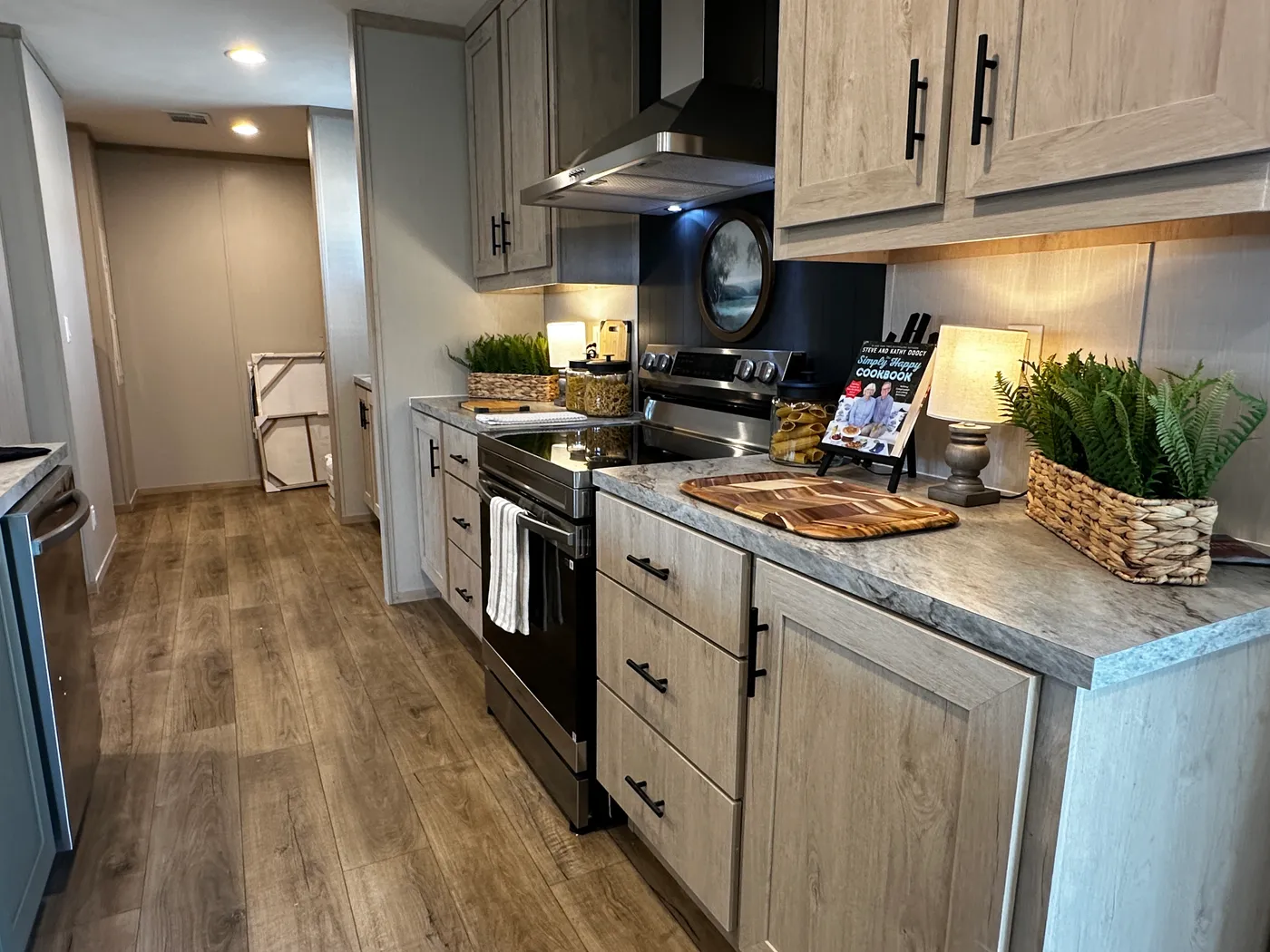 Spacious 3 bedroom, 2 bathroom double wide manufactured home built for comfort and family living. This open layout features both a living room and separate den, perfect for movie nights, entertaining, or creating private space for kids and adults. The modern kitchen includes stainless steel appliances and ample cabinet space. Enjoy year-round comfort with energy-efficient upflow ceiling vents for improved airflow. The private primary suite offers a relaxing retreat with a large soaking tub and s