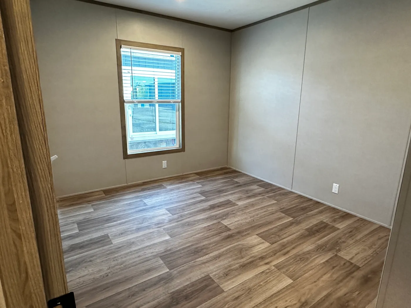 Modern luxury meets affordability in this 3 bedroom, 2 bathroom double wide manufactured home designed for comfort and style. The open-concept layout features a spacious living area with a gorgeous built-in entertainment center and plenty of natural light. The designer kitchen includes stainless steel appliances, a large kitchen island, and ample cabinet space, perfect for cooking and entertaining. Enjoy enhanced comfort with energy-efficient upflow ceiling vents for improved airflow throughout 