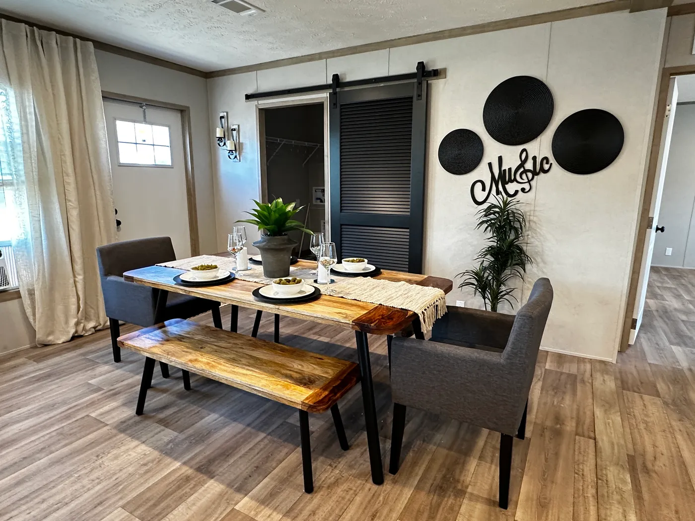 Modern luxury meets affordability in this 3 bedroom, 2 bathroom double wide manufactured home designed for comfort and style. The open-concept layout features a spacious living area with a gorgeous built-in entertainment center and plenty of natural light. The designer kitchen includes stainless steel appliances, a large kitchen island, and ample cabinet space, perfect for cooking and entertaining. Enjoy enhanced comfort with energy-efficient upflow ceiling vents for improved airflow throughout 