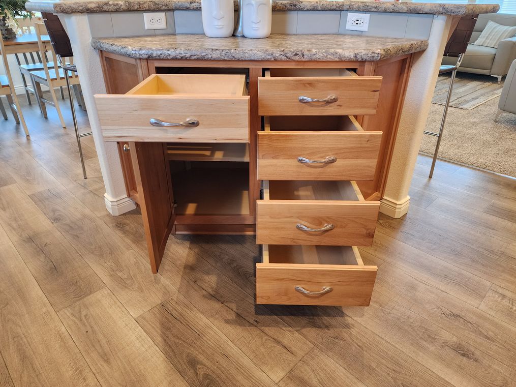 Island kitchen with 5 drawers and one cabinet.