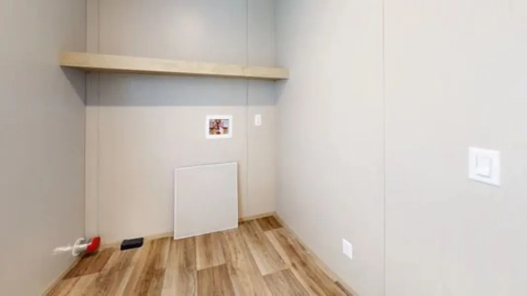 A heavy-duty laundry room equipped with built-in cabinets, a folding station, and dedicated space for a deep freezer.
