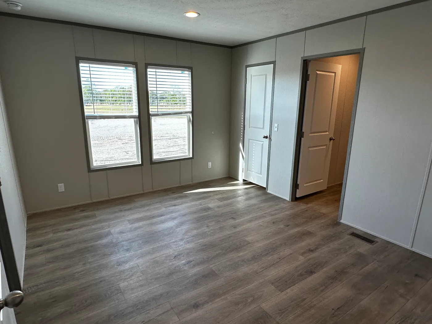 Affordable luxury meets modern comfort in this 3 bedroom, 2 bathroom manufactured home designed for spacious living and energy efficiency. The open-concept layout features a stylish kitchen with stainless steel appliances and a large walk-in pantry for extra storage. The private primary suite includes a generous walk-in closet and a relaxing retreat feel. Enjoy improved comfort with ceiling air vents for better airflow and temperature control throughout the home. This energy-efficient home offer