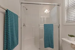 Full length shower with door in primary bathroom