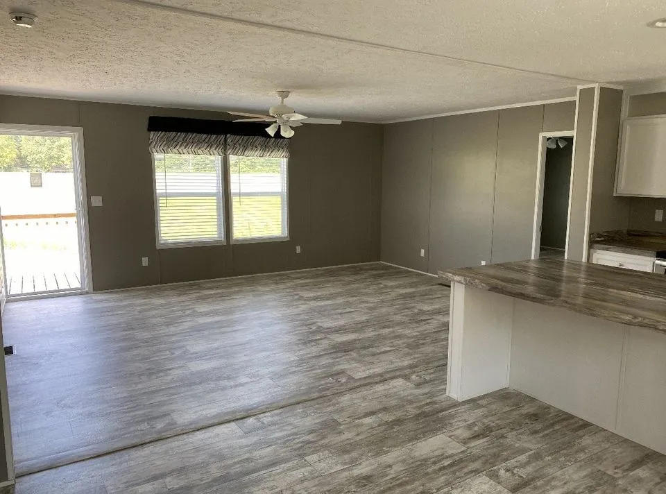 Enjoy an inviting open-concept living space with a stylish eat-at bar, perfect for casual dining and entertaining!