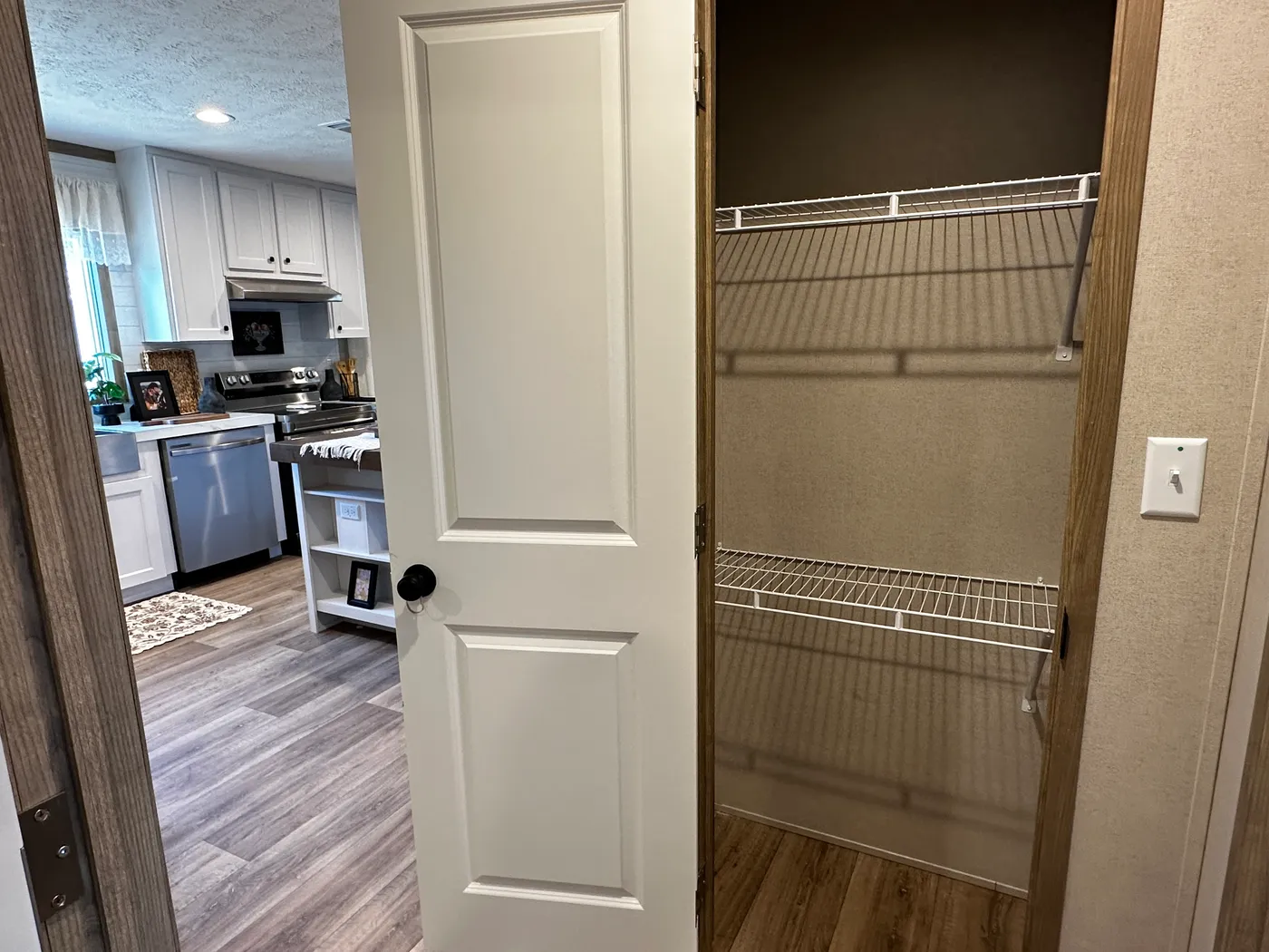 Modern luxury meets affordability in this 3 bedroom, 2 bathroom double wide manufactured home designed for comfort and style. The open-concept layout features a spacious living area with a gorgeous built-in entertainment center and plenty of natural light. The designer kitchen includes stainless steel appliances, a large kitchen island, and ample cabinet space, perfect for cooking and entertaining. Enjoy enhanced comfort with energy-efficient upflow ceiling vents for improved airflow throughout 