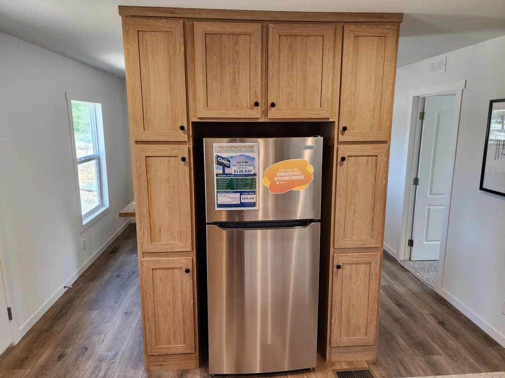 Stainless refrigerator & lots of cabinets.