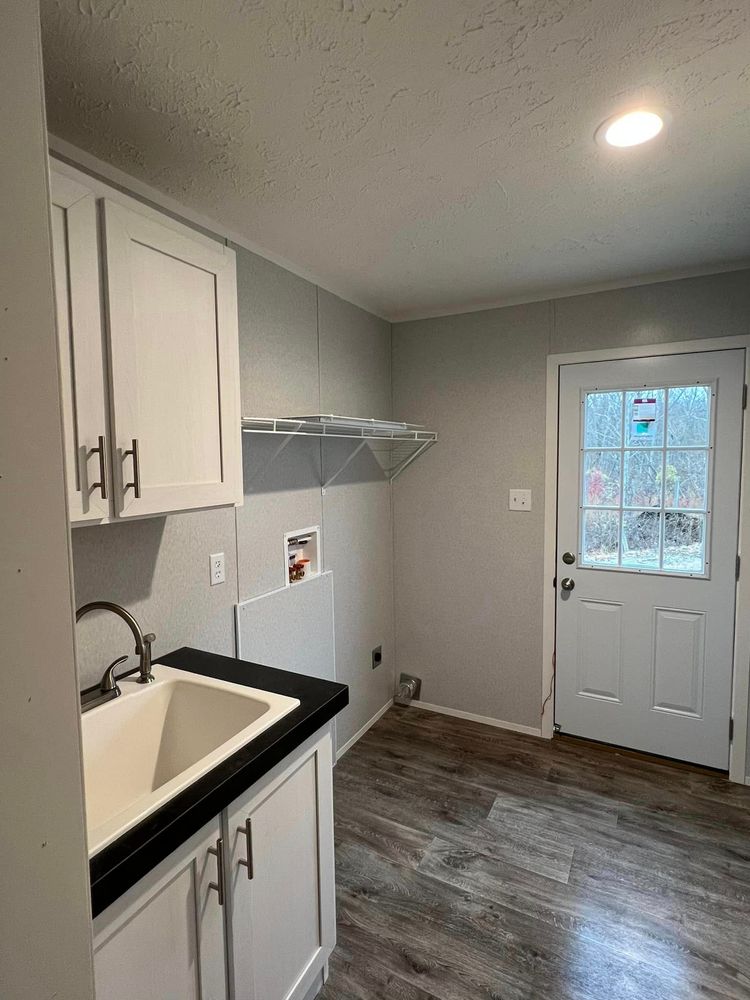 utility room has the option for a sink and cabinets. 