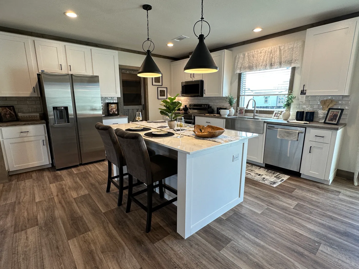 Discover The Summit, a stunning luxury doublewide manufactured home at Clayton Homes of Alvin, Texas! Designed for modern living, this beautiful home features a spacious open-concept floor plan, elegant interior finishes, and an impressive gourmet kitchen with a massive center island, stainless steel appliances, and abundant cabinet space. Enjoy generous living areas, spacious bedrooms, walk-in closets, and a luxurious primary suite designed for comfort and relaxation. Combining modern farmhouse