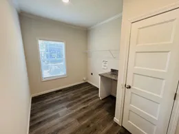 Features a side door and additional window to provide great natural light throughout the day. Folding table adjacent to washer and dryer space provides a great place to add a mini fridge in space below, fold clothes, or store the next load of laundry to be washed. 