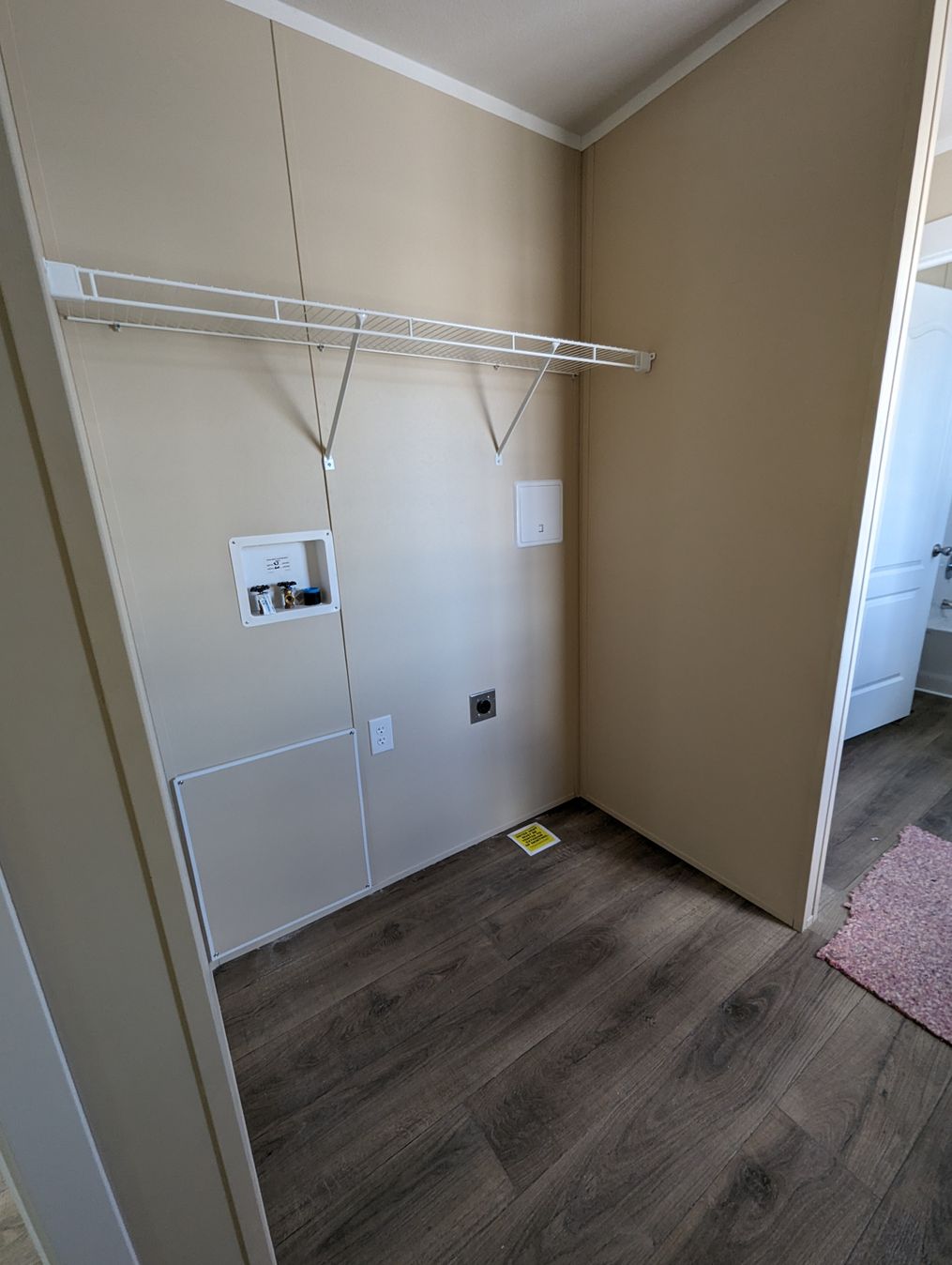 Utility room for washer and dryer with wire shelving.