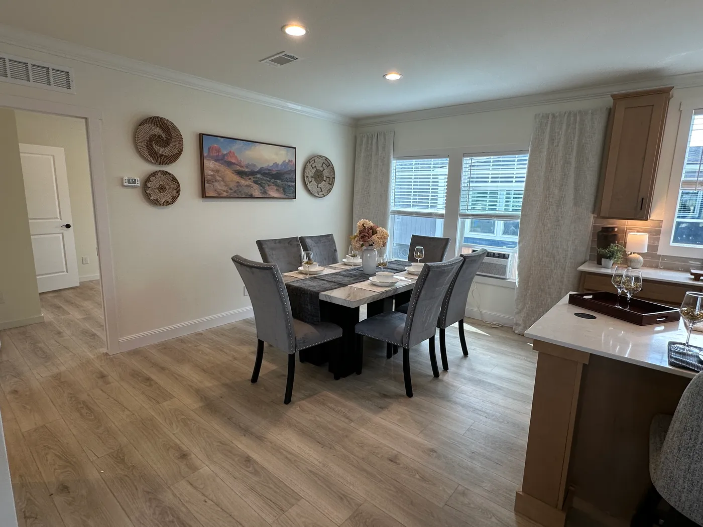 Discover The Cambridge, a stunning 3-bedroom, 2-bath luxury manufactured home at Clayton Homes of Alvin, Texas! This beautiful home features tape-and-textured walls, elegant crown molding, gorgeous quartz countertops, and a Samsung Smart Refrigerator. The gourmet kitchen includes a hidden walk-in Butler’s pantry with extra shelving and a second refrigerator for exceptional storage. The luxurious primary bedroom showcases a beautiful illuminated accent wall, while the spa-inspired primary bathroo